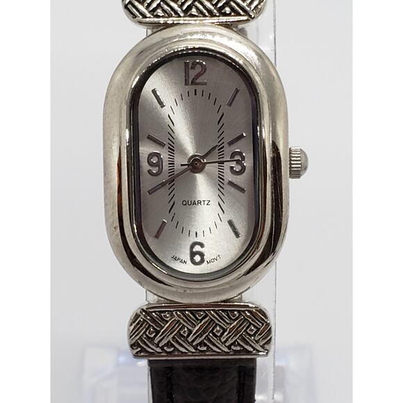 Women's dress watch. Oval face. Decorative design for buckle from face to band